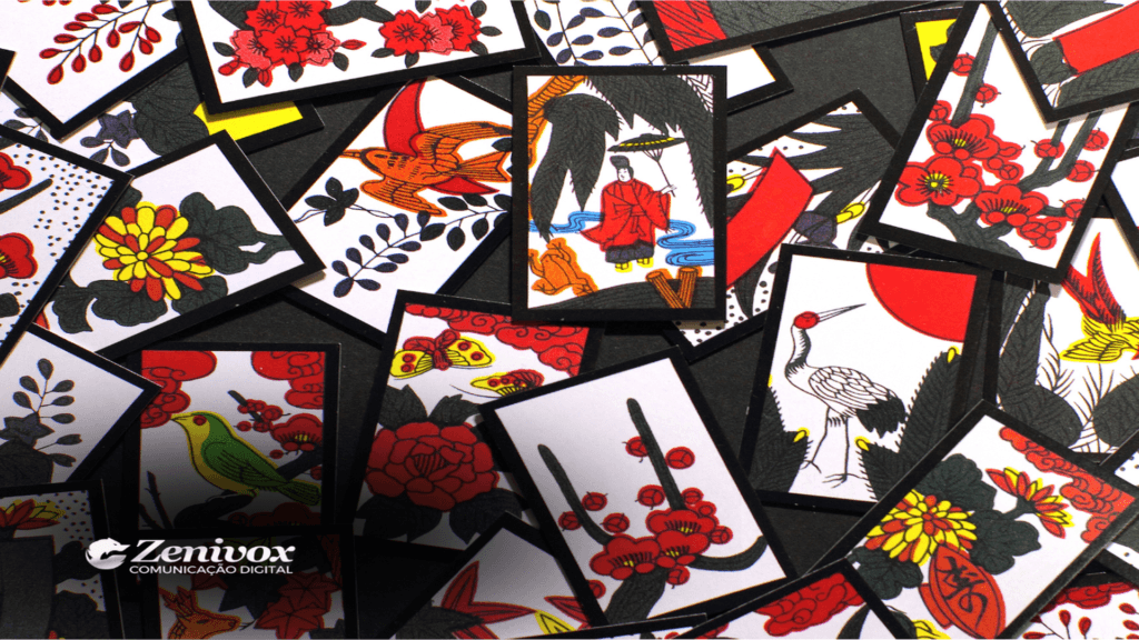 Cartas hanafuda tradicionais espalhadas em um fundo escuro, exibindo ilustrações vibrantes com flores, pássaros e elementos japoneses. Essa imagem remete à história da Nintendo e sua origem na fabricação de cartas hanafuda.