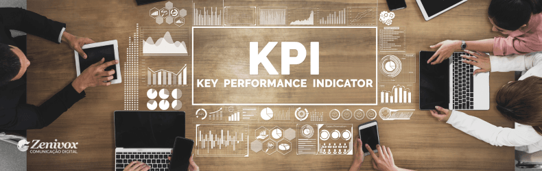 Mesa de reunião com profissionais analisando dados em dispositivos como tablets e laptops. No centro da imagem, o termo "KPI - Key Performance Indicator" está destacado, cercado por gráficos digitais representando métricas de desempenho. O logotipo da Zenivox Comunicação Digital está no canto inferior esquerdo, reforçando a identidade visual da marca.
