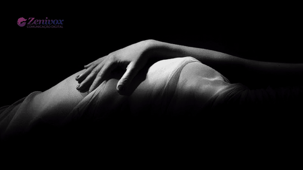 Mão feminina repousando suavemente sobre um tecido translúcido, destacada em preto e branco, transmitindo a ideia de de campanhas publicitárias sensuais. Branding da Zenivox no canto superior esquerdo.